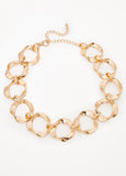 Necklace with twisted rings in gold-tone metal. Lobster-clasp fastening.